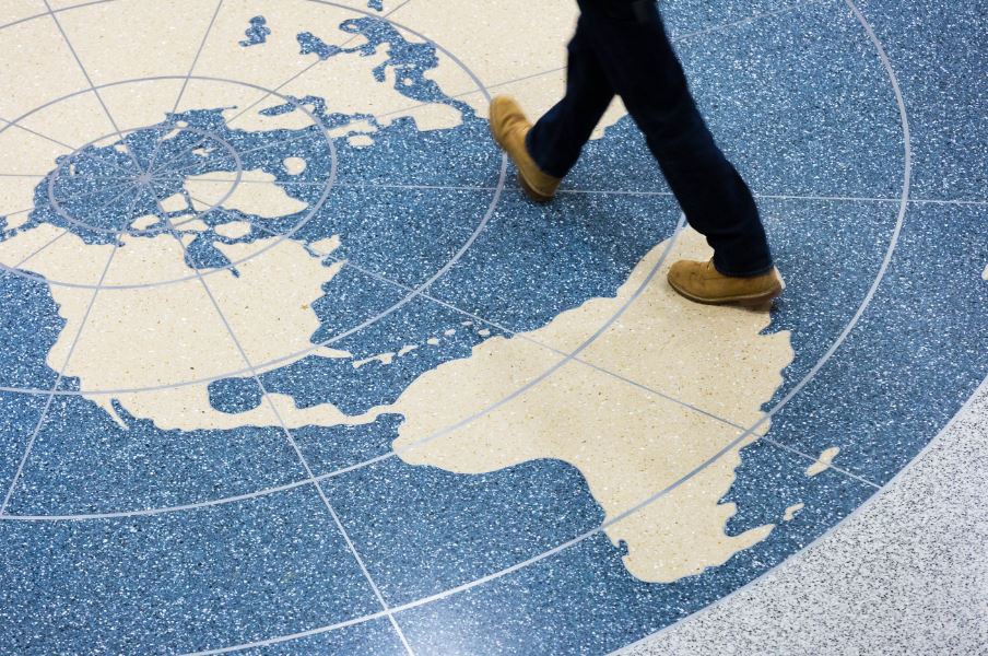 person walking on tile with map