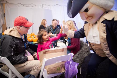 Colonial mascot gives high-five to child
